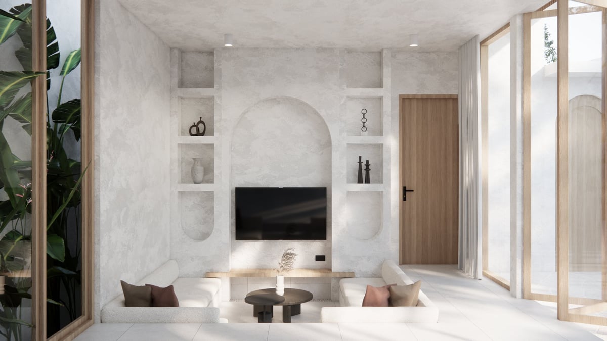 Modern minimalist living room with lime-washed white walls, built-in shelving, wall-mounted TV, and natural light from floor-to-ceiling windows