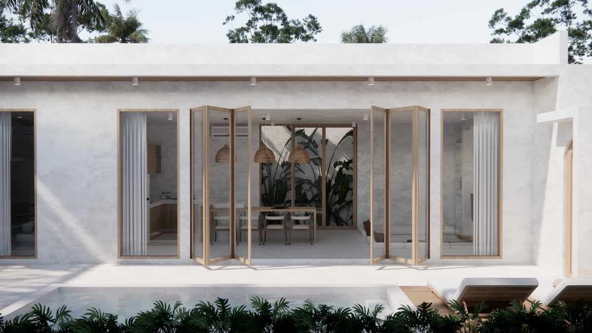 Modern white house with large open bi-fold glass doors leading to a bright interior space and patio area